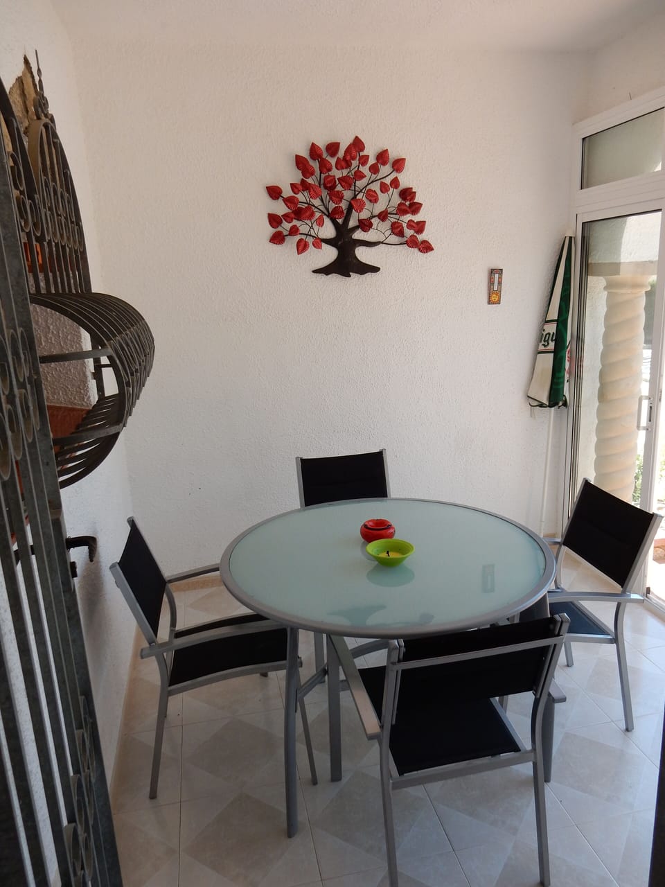 Enclosed glass door terrace with table and chairs