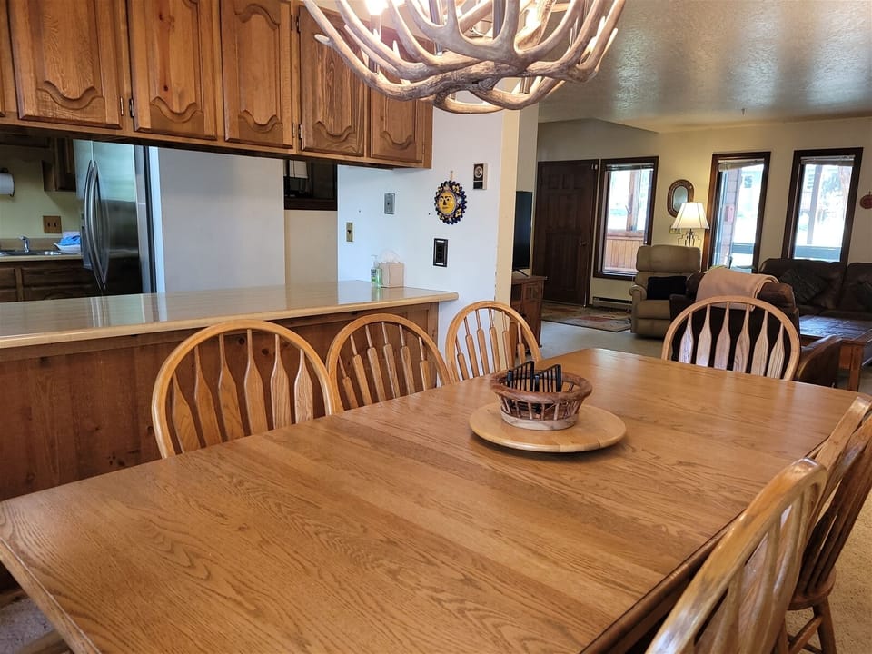 Dining area with seating for 8 at the table and 2 more seats at the breakfast bar
