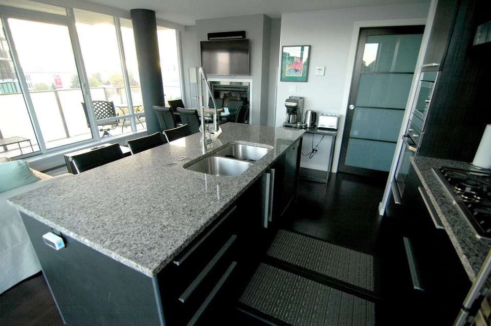 Kitchen: stocked with plenty of glasses, dishes, utensils, stainless steel pots