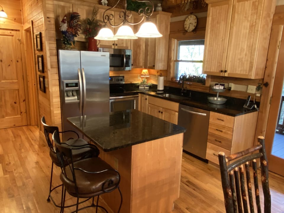 Fully stocked kitchen with stainless steel appliance and granite countertops.