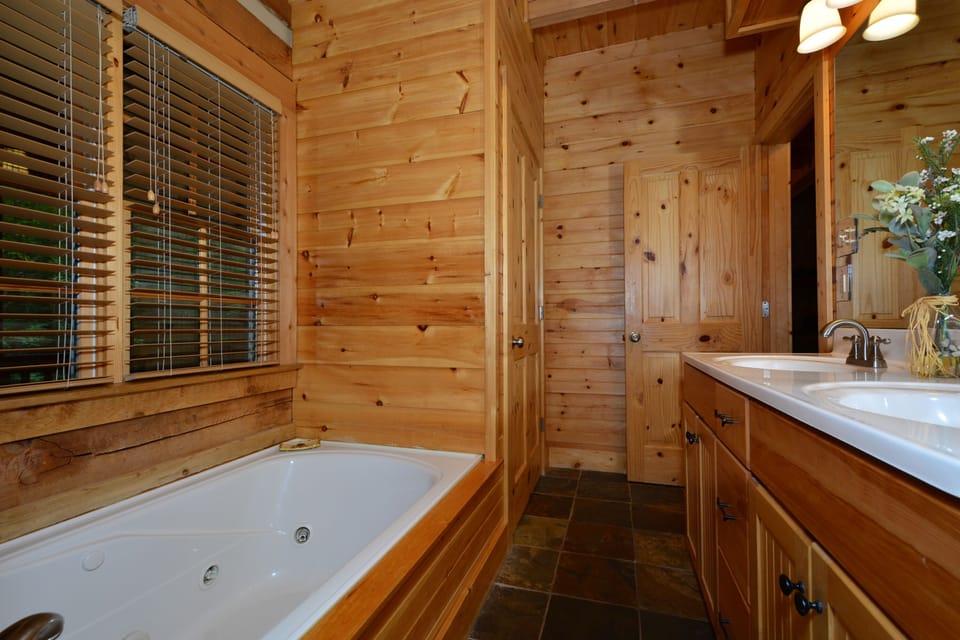 Master Bathroom with double vanity, Jacuzzi tub, and stand up shower.
