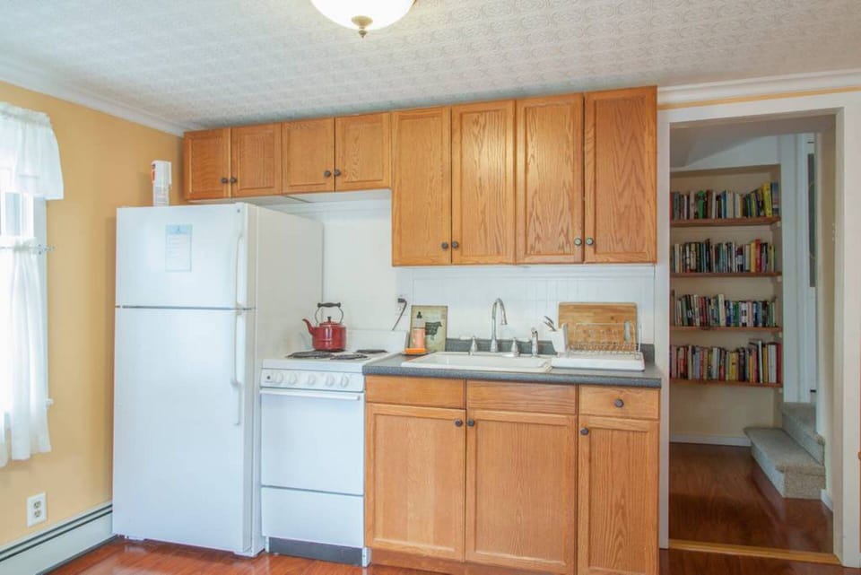 The other side of the large eat in kitchen and the eclectic vacation library.