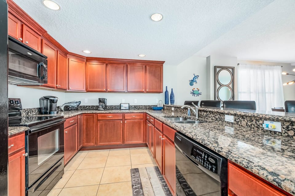 Large fully stocked kitchen with peninsula breakfast bar