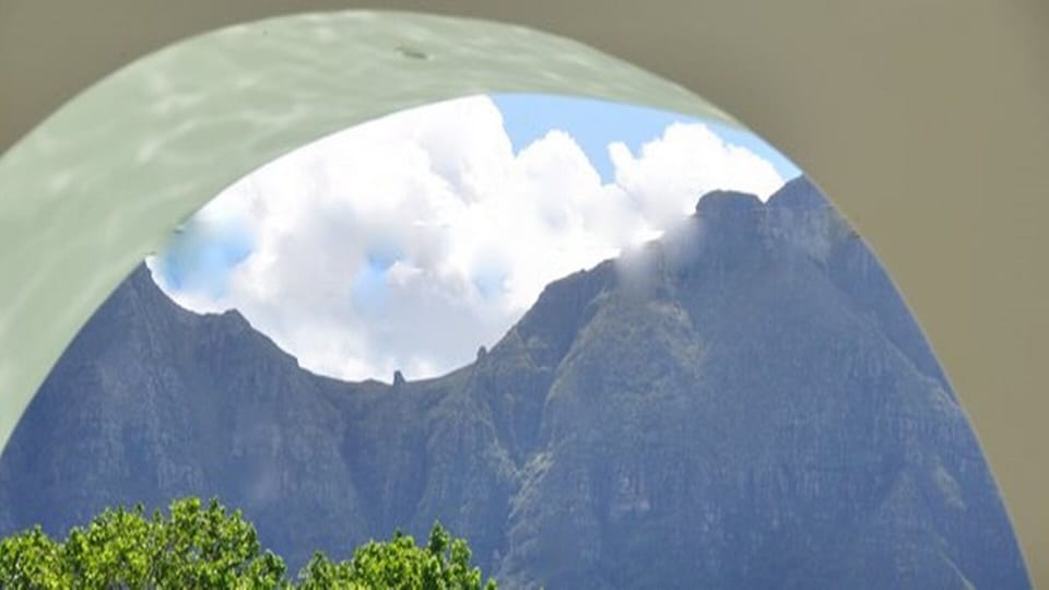 Mountain view looking through one of the arches over the pool & decking big pati