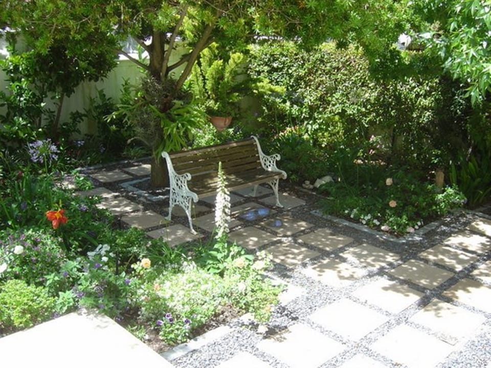 Bench in garden to sit, relax and contemplate. Looking onto lovely garden.