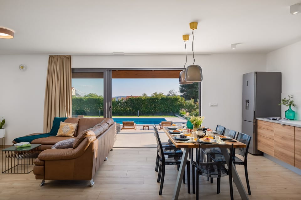Living room and dining table on the ground floor with completely open door