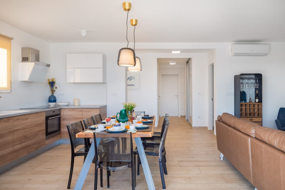 Dining table and kitchen with hallway