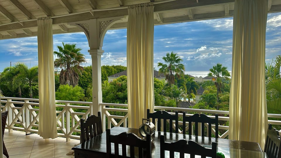 The balcony is wide with a seating and dining area to enjoy the beautiful view 