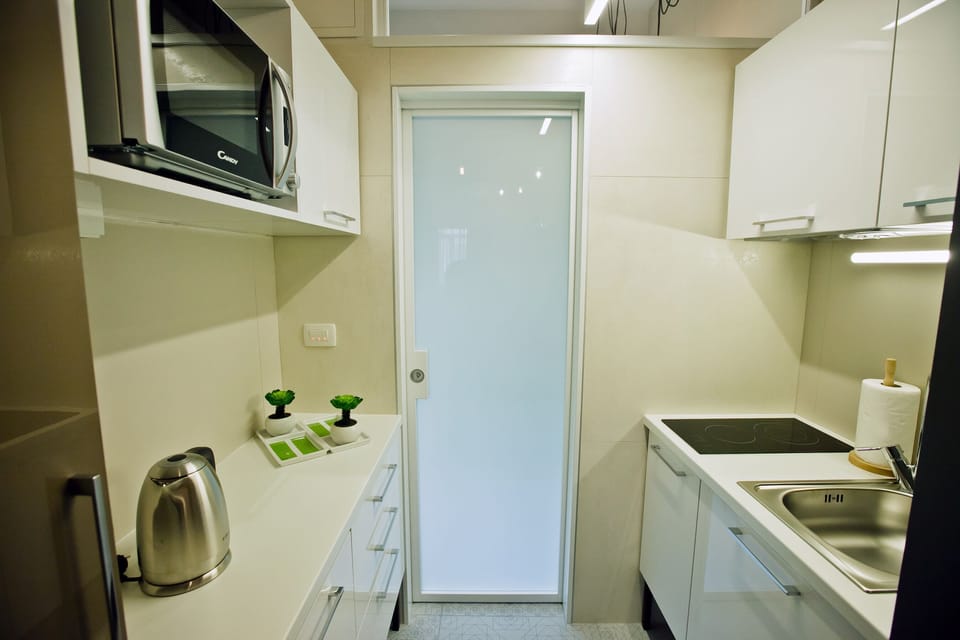 Fully equipped kitchen with stove, microwave kettle, toaster, dishes & utensils
