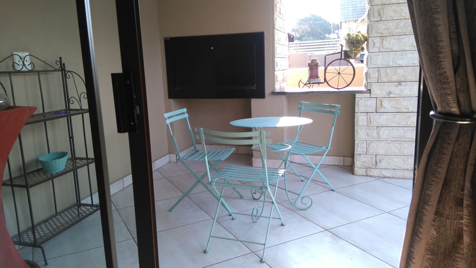 Patio with built in barbeque looking onto small private indigenous garden
