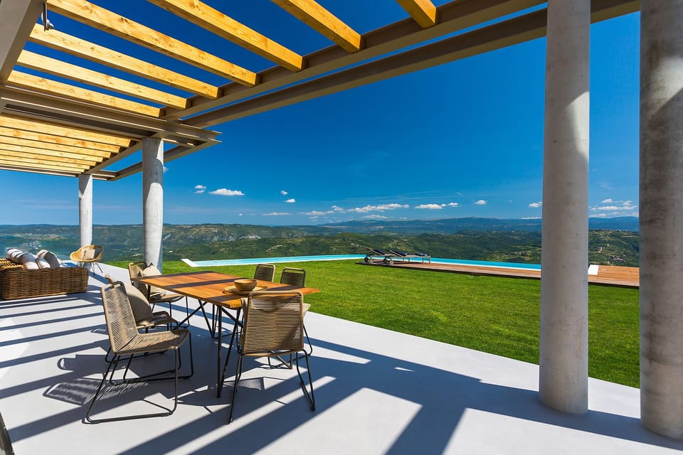 view of the swimming pool and the surroundings from the outdoor dining table
