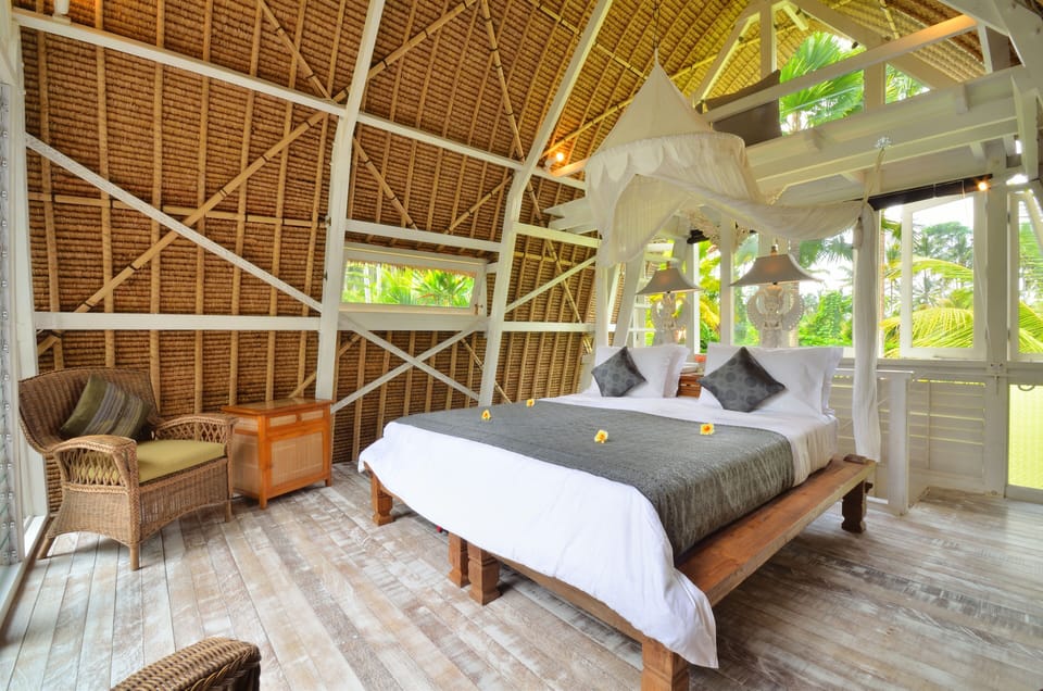 The White Elephant: Upstairs bedroom with soaring alang-alang ceiling and loft