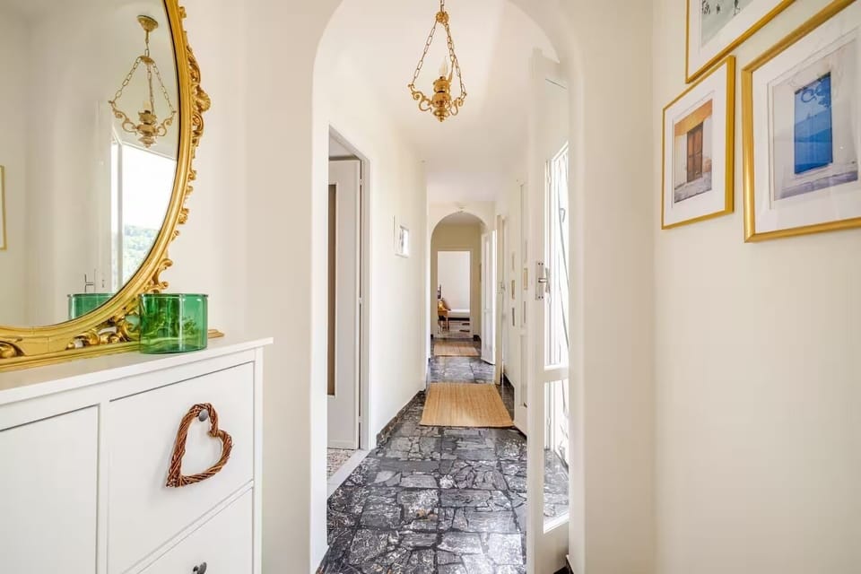 Hallway with large shoe cupboard and above it an antique mirror