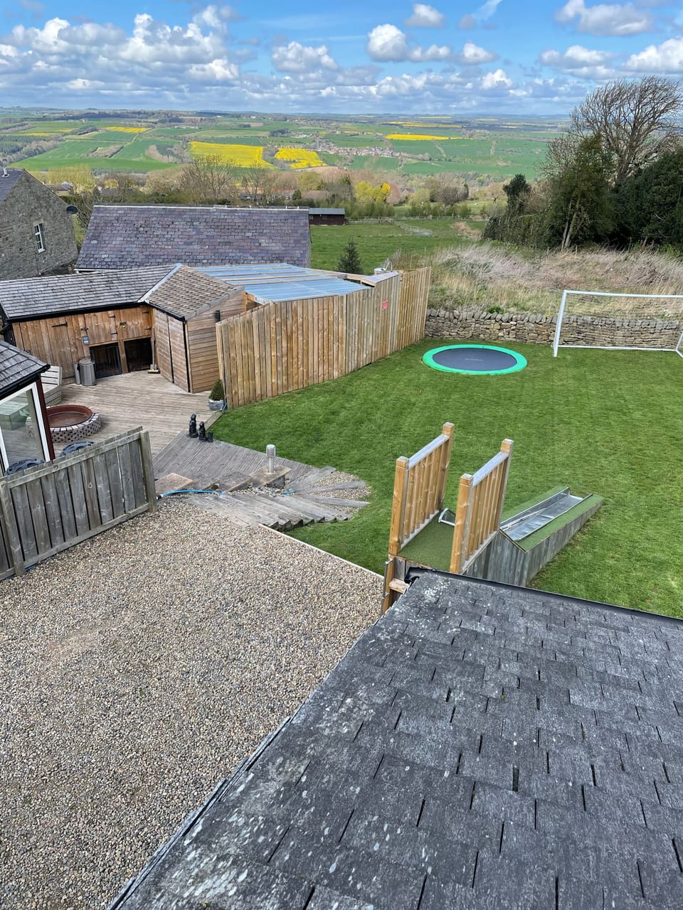 Ariel view of cottage showing decking, hot tub and children’s garden facilities 