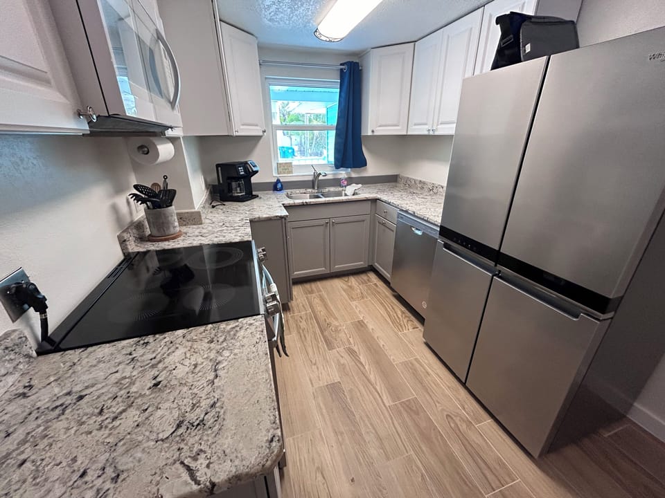 Kitchen with granite countertops, new induction range, and new refrigerator