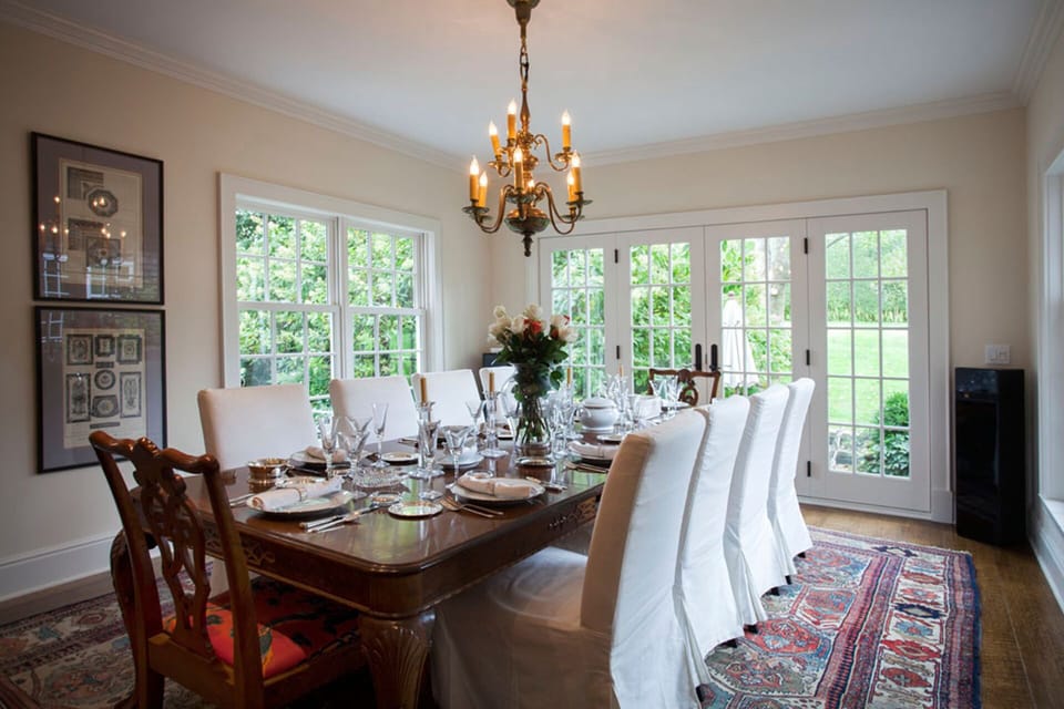 dinning room with windows/French doors on 3 sides. Table expands to seat 14. 