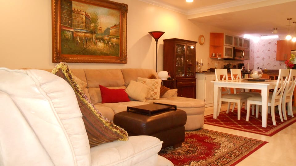 Living room open concept view with Comfy Sectional and 50"' tv