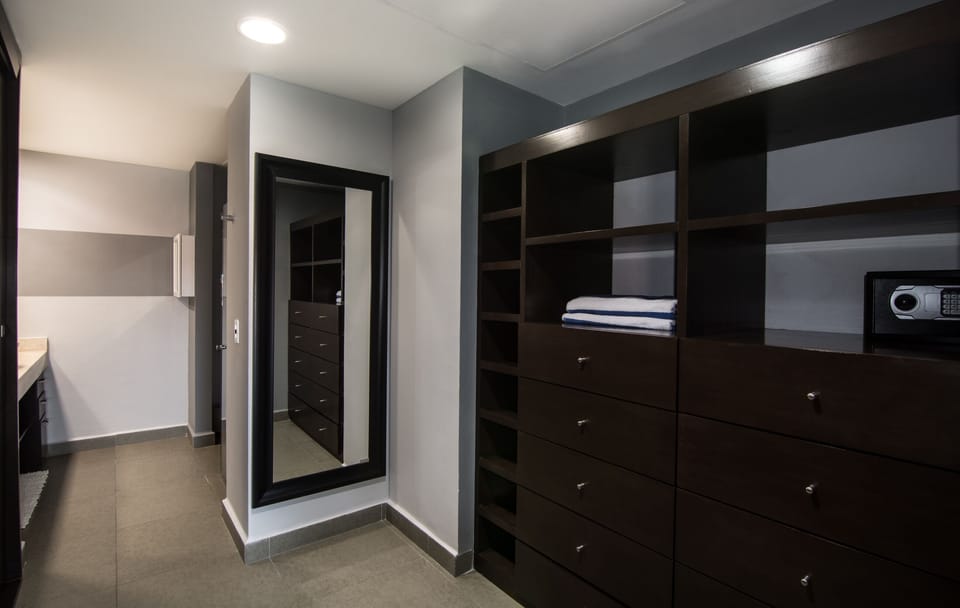 Master bedroom closet with tons of space and a safe for your valuables