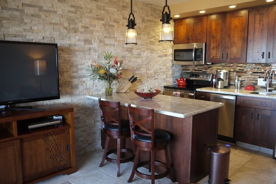 Open concept kitchen and living room area. Peninsula serves as dining space.