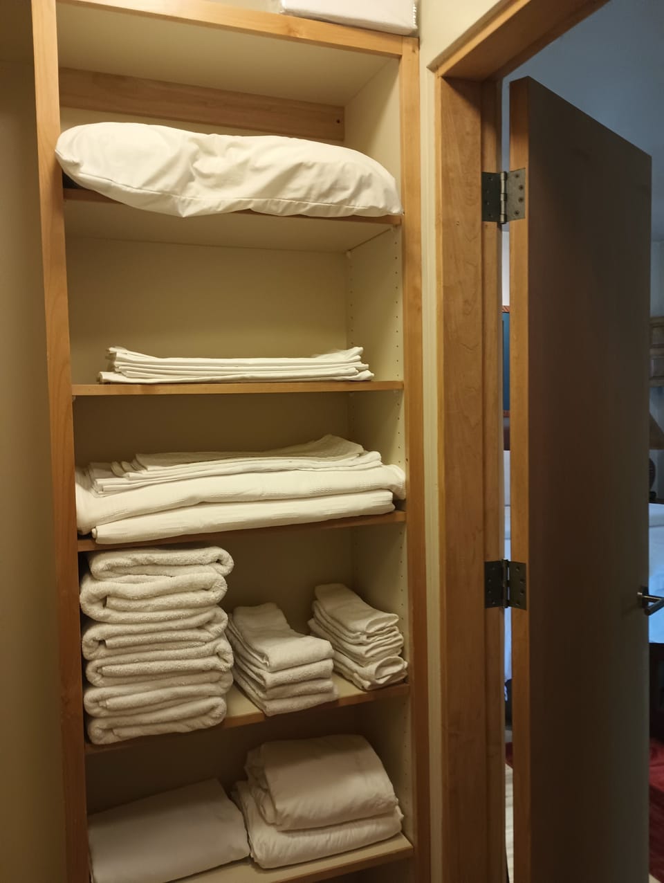 Extra linens and towels and different types of pillows.