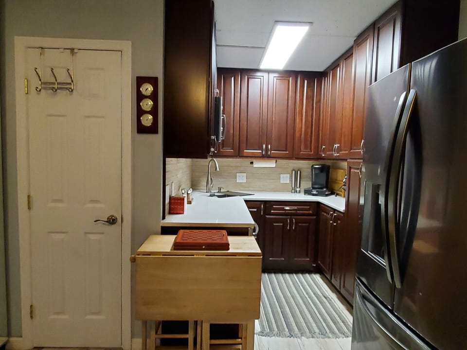 The kitchen also includes an induction cooktop and foldable dining table