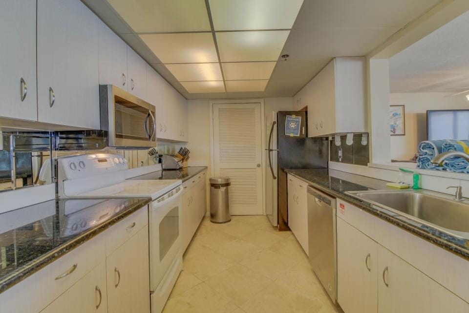 Huge kitchen with new stainless steel dishwasher, microwave and convection oven.