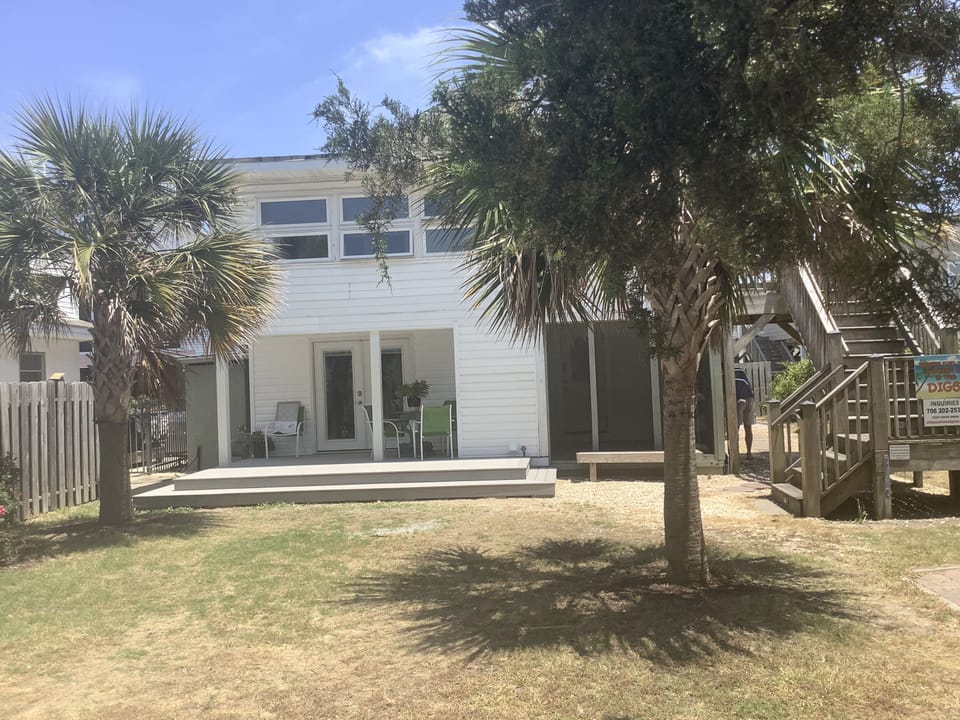 Yard and lower level entrance - + stairs to upper deck, porch and upper unit.