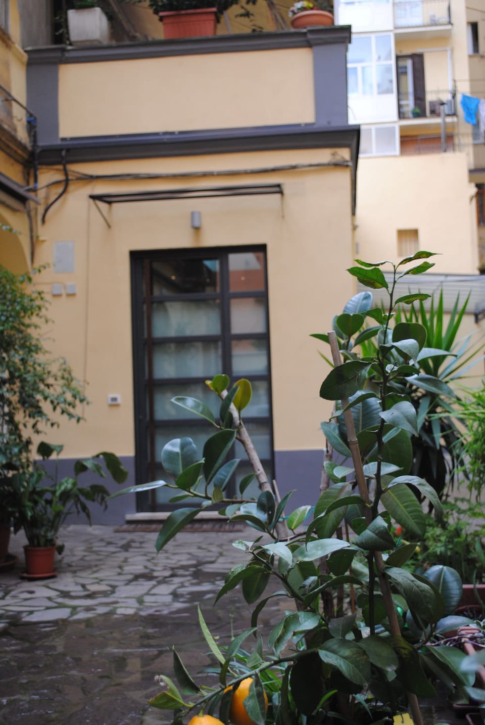 Loft entrance in a calm and sunny courtyard