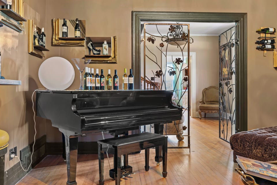 Speakeasy wine room with baby Grand