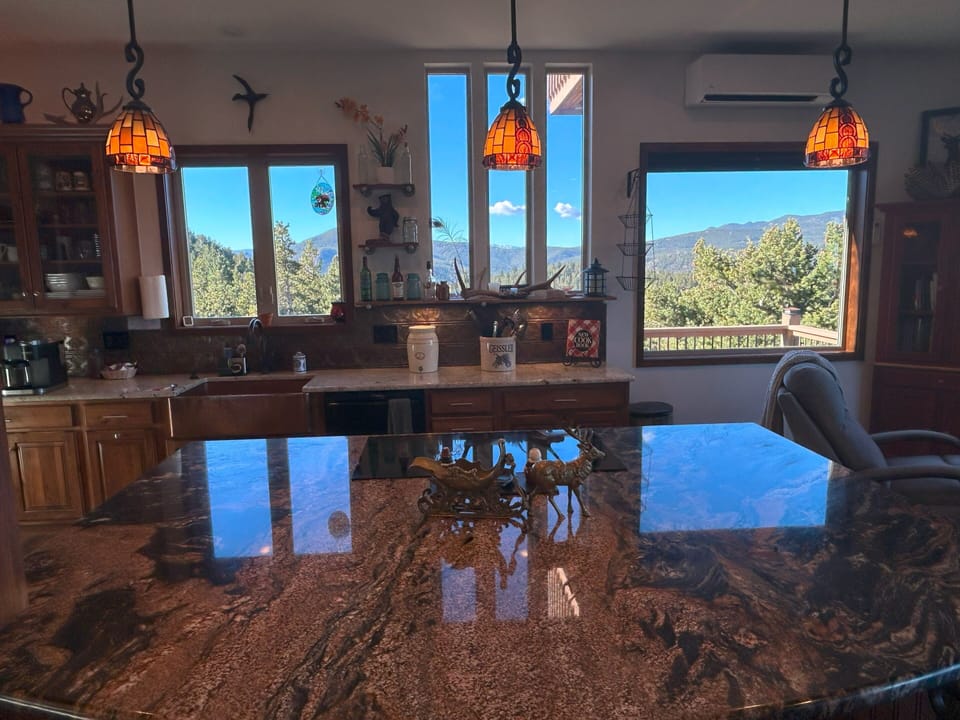 Granite counters, A/C, induction stovetop, copper sink, antique backsplash,views