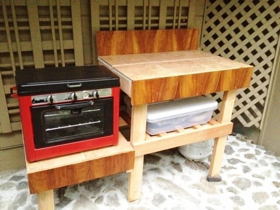 Outdoor shared 2 burner stove/oven.  BBQ grill available but not shown