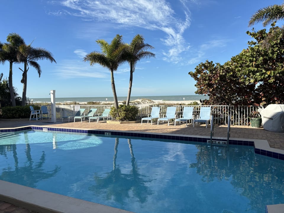 Pool area with ample seating and BBQ grill, with breathtaking view of the beach!