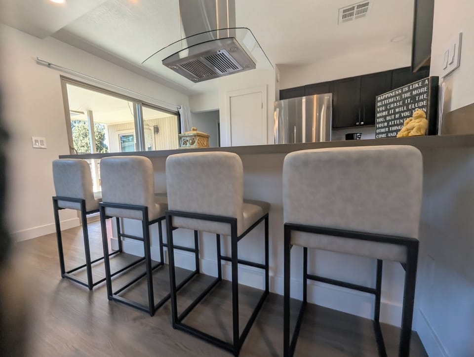 Barstools at kitchen counter, from living / dining room.