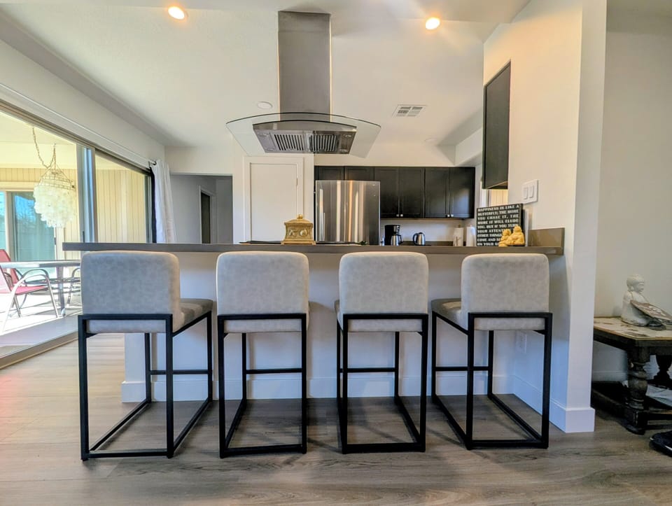 Barstools at kitchen counter, from living / dining room.