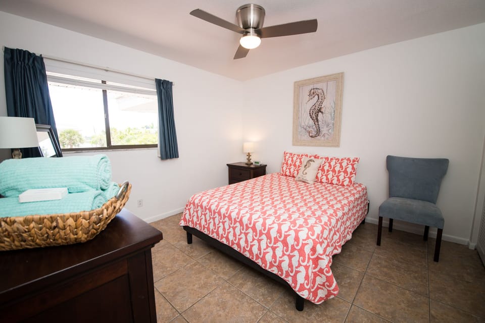 Guest Bedroom with queen bed, single air mattress, fan, dresser, closet,bathroom