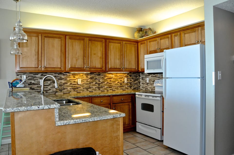 Updated kitchen with mosaic backsplash.