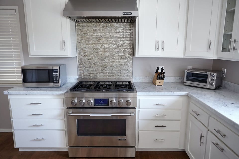 Chef's kitchen with modern appliances and marble countertops