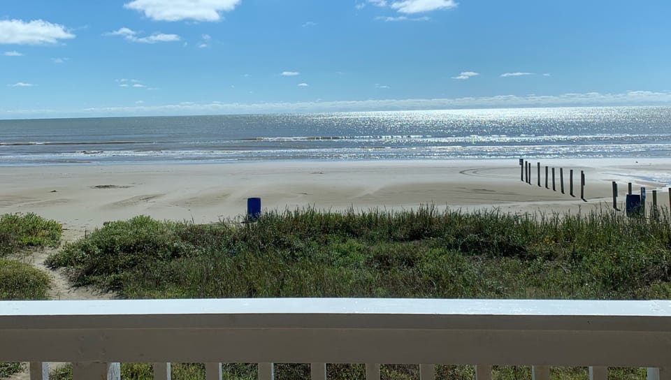 View of beach from main level balcony. 