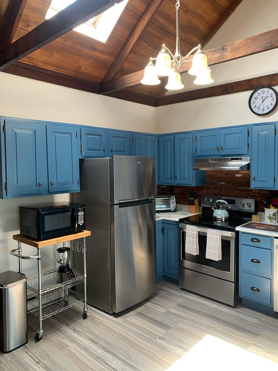 Kitchen has electric stove and fully applianced.