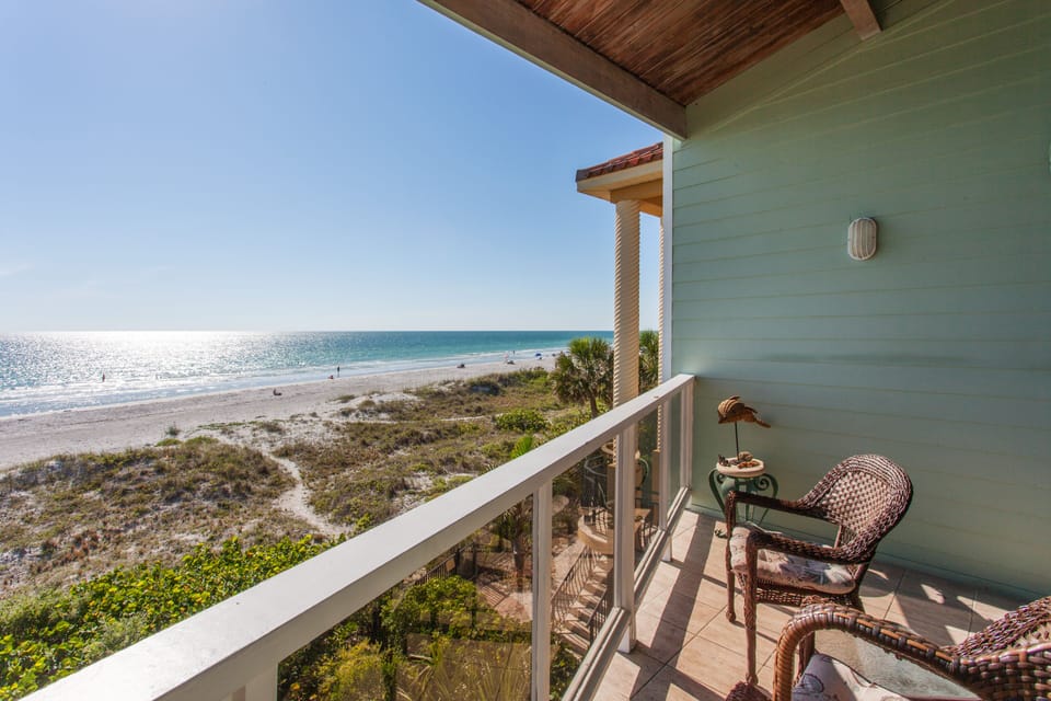Enjoy a cocktail as the sun sets from the balcony off the family room
