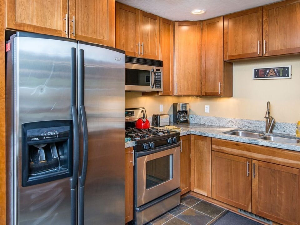 Stainless steel appliances feature in the kitchen.