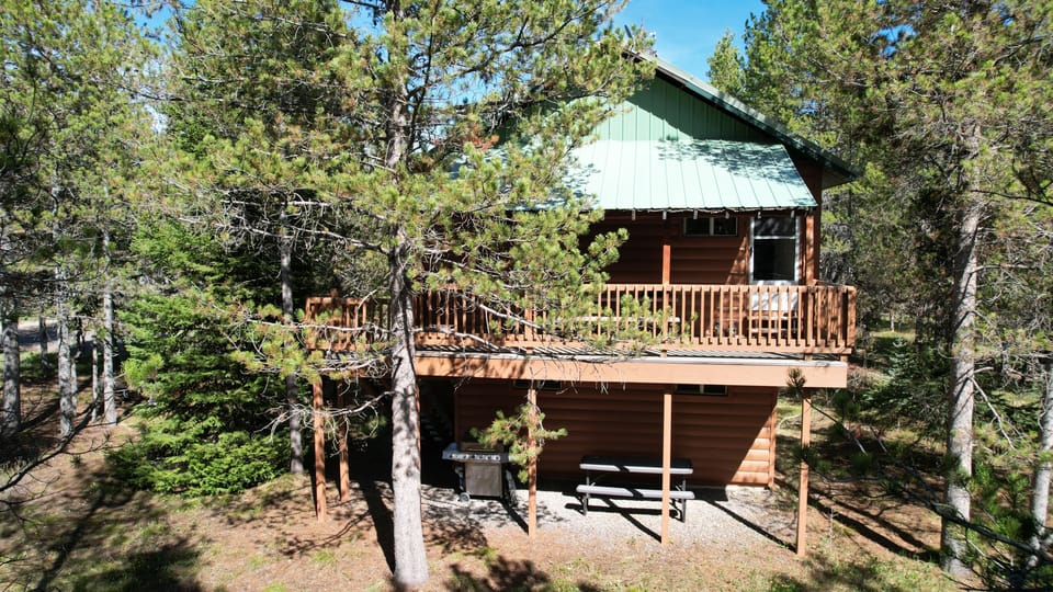 Cozy Cabin side with porch and patio.