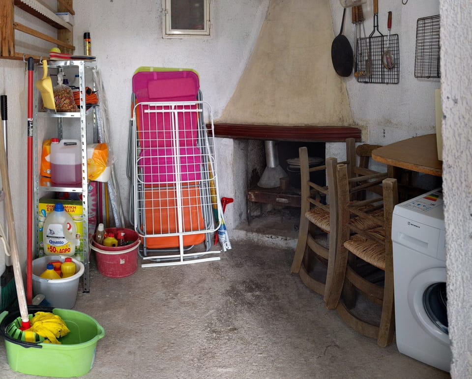 Laundry and storage room with a small fireplace.