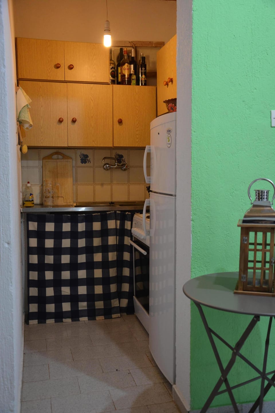 Kitchen area with full size fridge, oven and stoves