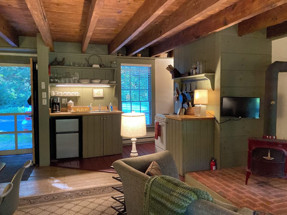 Kitchen area with small refrigerator.  Standard size refrigerator in basement.