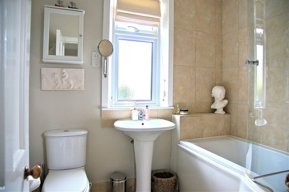 Bathroom with over bath shower