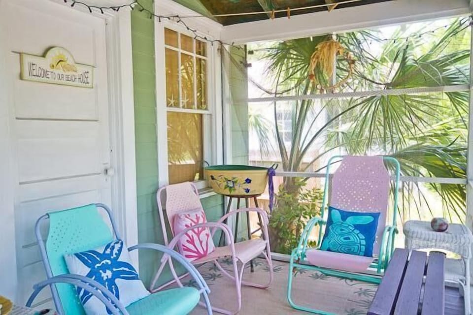 Enjoy the sights and sounds of Island life from this adorable screened porch.