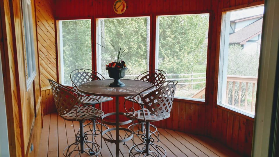 The screened sun porch is a great place for "outdoor" meals, rain or shine.