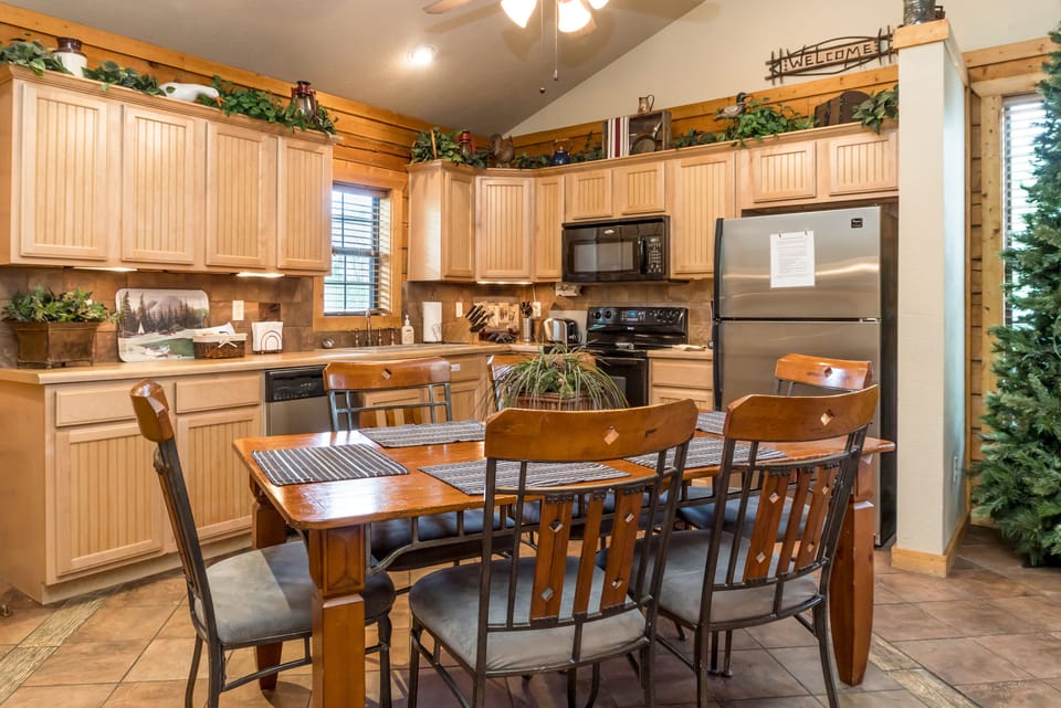 Full size kitchen with plenty of cabinets, counter space & table seating for six