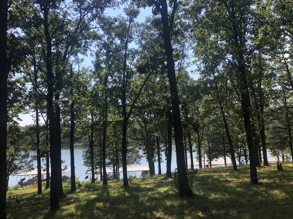 Unobstructed lake/dock view from the back deck with gentle slope to the lake
